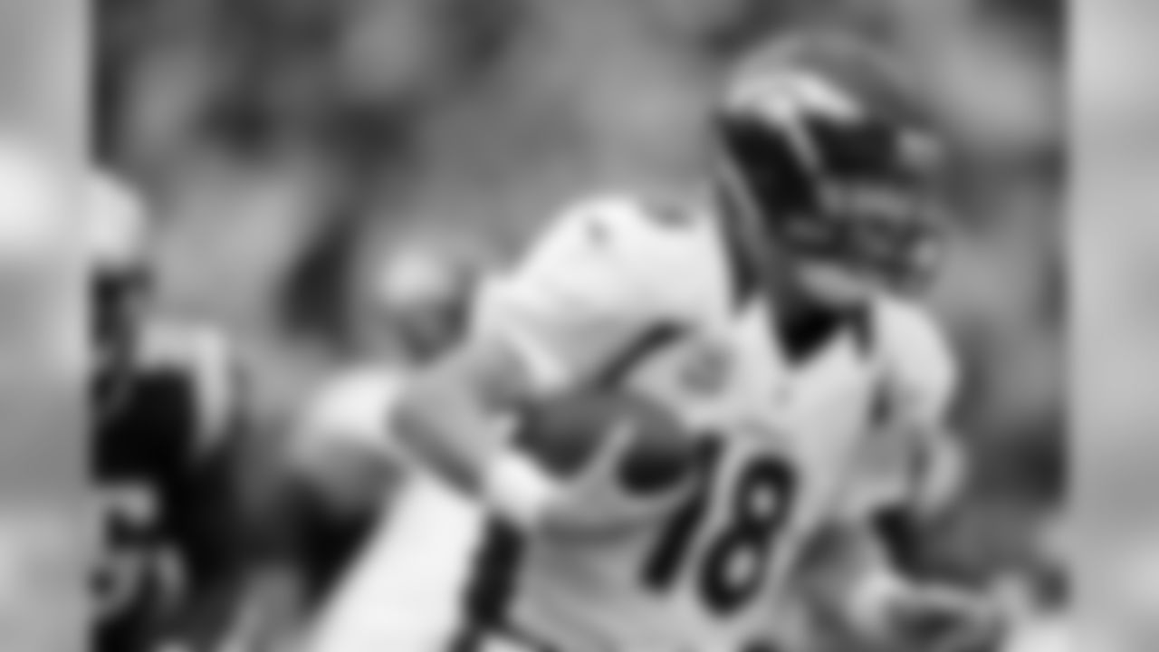 QB Peyton Manning takes off downfield during first-half action against the New England Patriots.