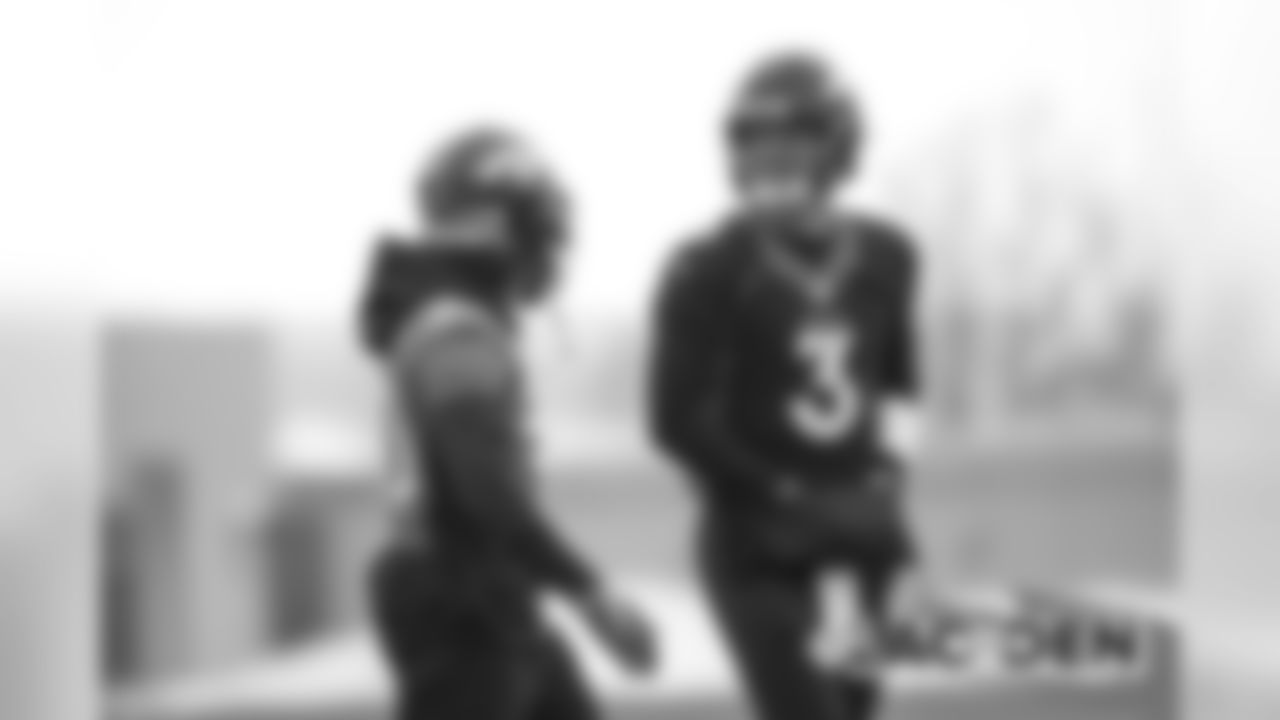 Drew Lock shares a laugh with Phillip Lindsay at practice at UCHealth Training Center on November 28, 2019. (Photo by Ben Swanson)