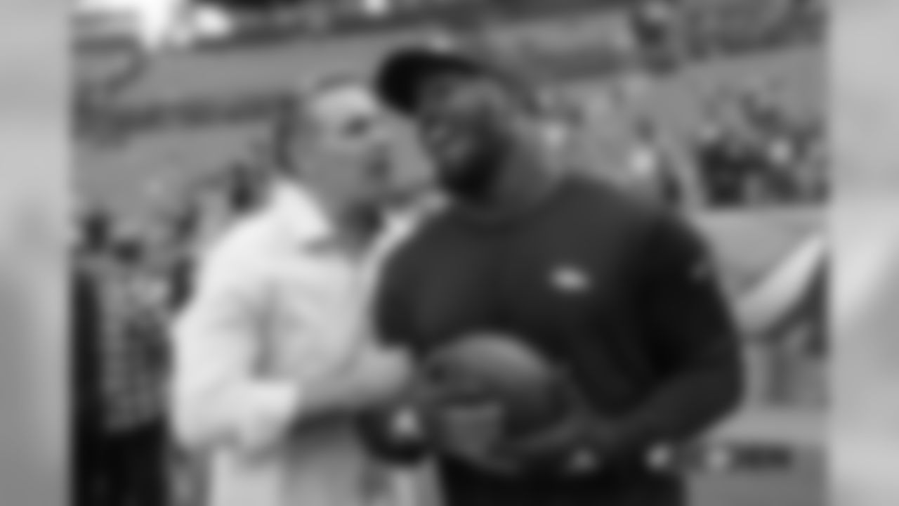 Von Miller and Pro Football Hall of Fame quarterback Kurt Warner share a laugh together while Miller warms up before the Broncos' game against the Chiefs.