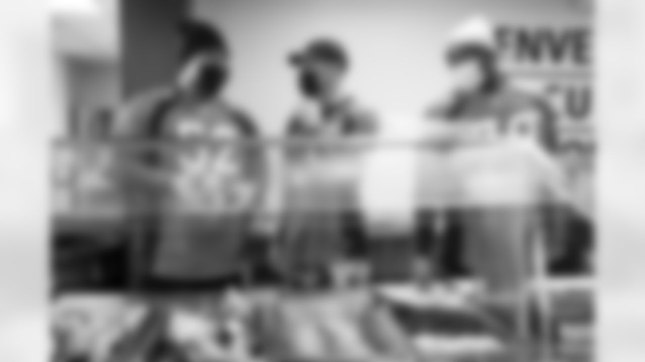 Netane Muti, Justin Simmons and Lloyd Cushenberry III help prepare and serve meals at Denver Rescue Mission in Denver, Colorado on October 5, 2021. (Photo by Sam Weaver)