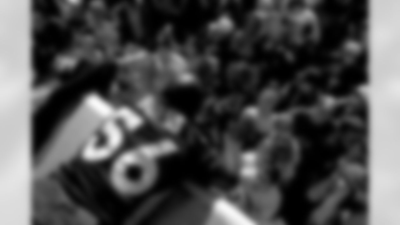 Denver: An estimated 650,000 fans turned out along 17th Street, Broadway and Civic Center Park to cheer on the Broncos during their Championship Parade, the day after returning from the Super Bowl. Here, Keith Burns signs autographs.