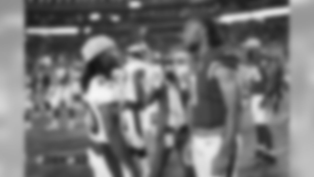 Adam Jones talks with Cardinals receiver Larry Fitzgerald after the Broncos' preseason game against the Arizona Cardinals on August 30, 2018.