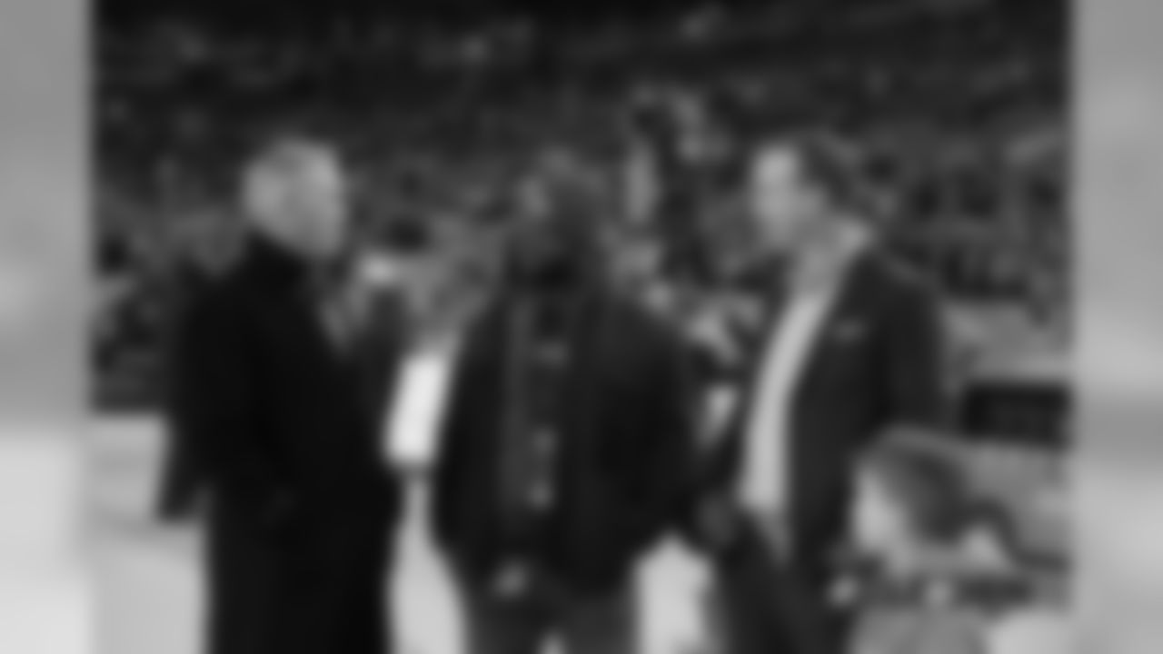 President of Football Operations/General Manager John Elway talks with former linebacker Al Wilson, Peyton Manning and Manning's son Marshall before the Broncos' Week 15 game against the Browns.