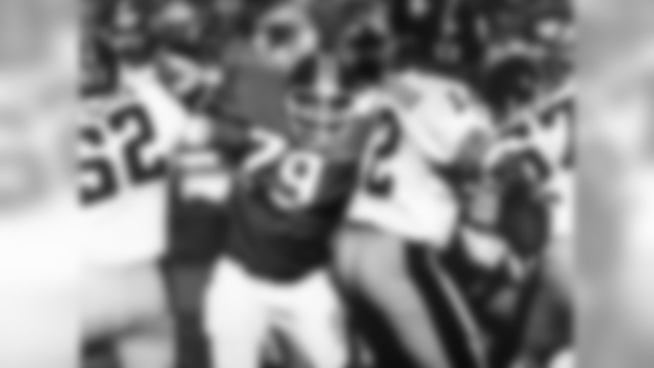 Defensive end Barney Chavous rushes Pittsburgh Steelers quarterback Terry Bradshaw during a game at Mile High Stadium.
