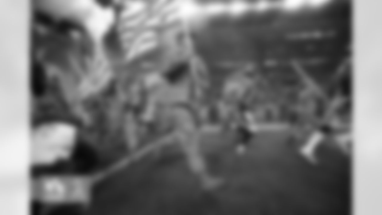 Players and military members run out of the tunnel during the game against the Kansas City Chiefs at Sports Authority Field at Mile High in Denver, CO, November 27, 2016.
Photo by Gabriel Christus