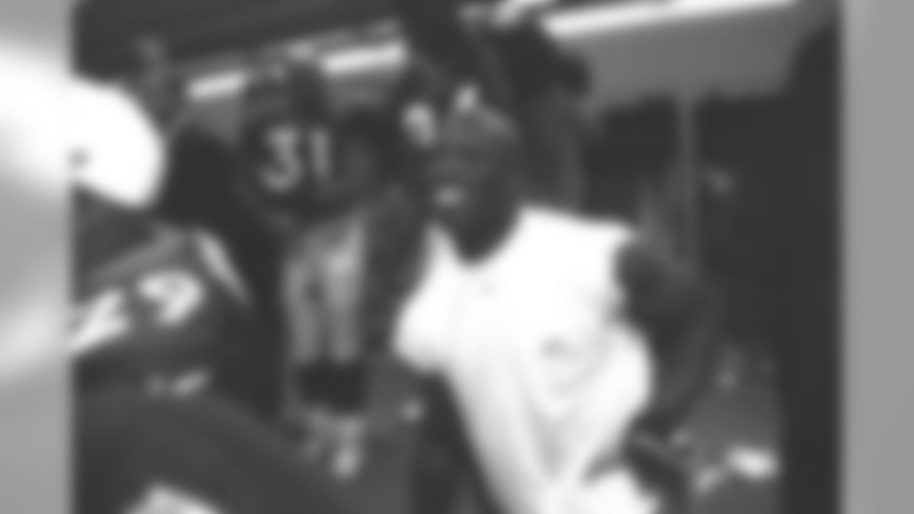 Terrell Davis waits to accept his game ball in the locker room after the game against the Seattle Seahawks at Mile High Stadium in Denver, CO on December 27, 1998.