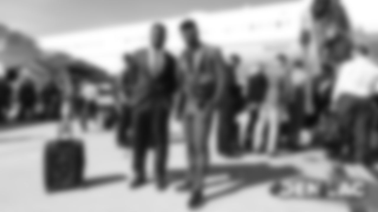 Jeremiah Attaochu and Von Miller on the tarmac at Denver International Airport during the team's travel to California on October 5, 2019 ahead of their Week 5 game against the Los Angeles Chargers. (Photo by Ben Swanson)