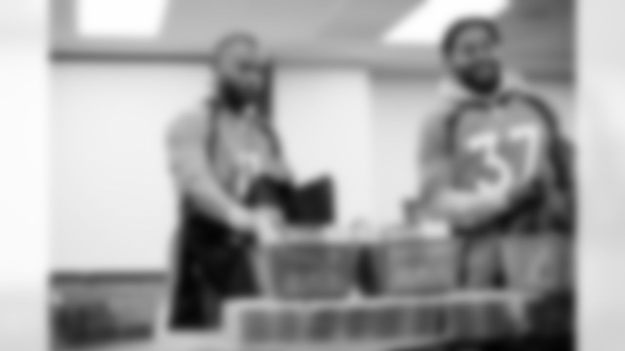 Diontae Spencer and P.J. Locke during a community event packaging school supplies provided by King Soopers in 300 backpacks for students on August 31, 2021. (Photo by Ben Swanson)