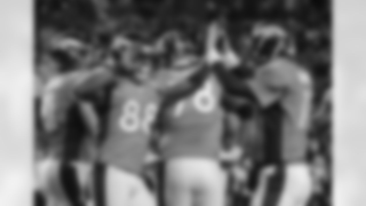 WR Demaryius Thomas high-fives Manning after catching a 1-yard touchdown pass.