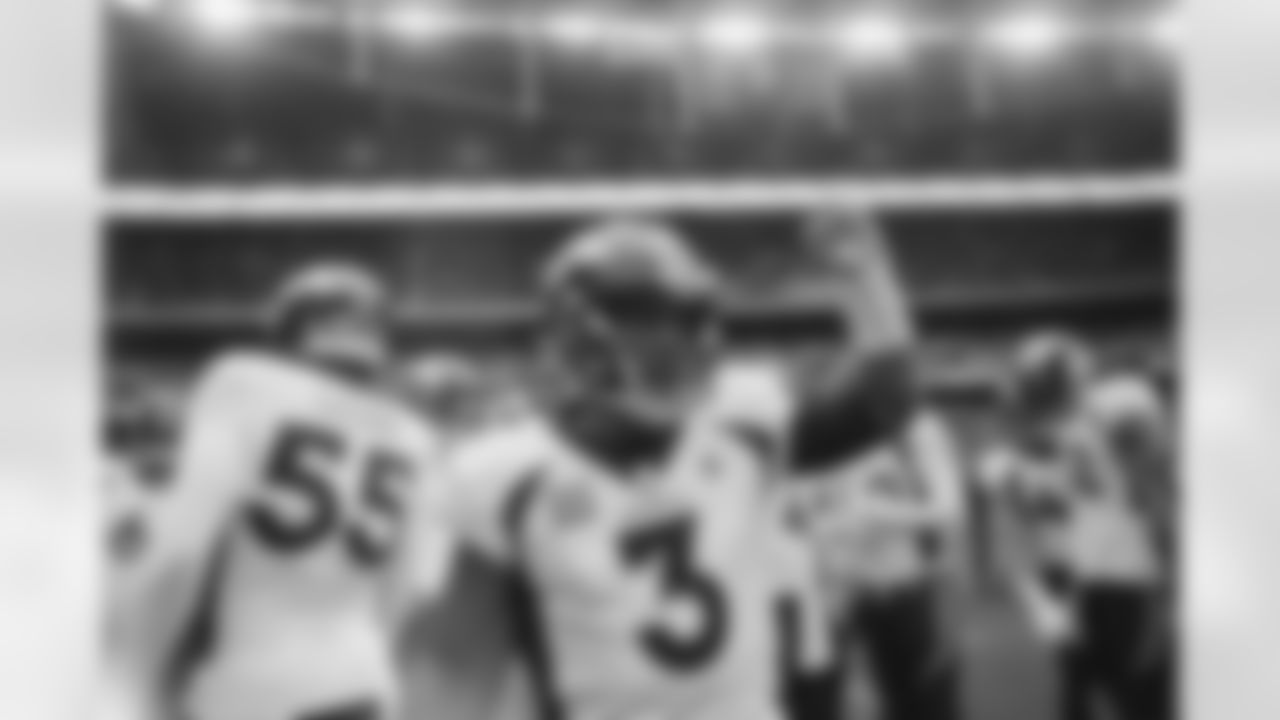 Russell Wilson speaks in the team huddle during the Broncos' Week 8 game against the Jaguars at Wembley Stadium in London on October 30, 2022. This image is part of the Broncos' film series documenting the team's trip to London. (Photo by Ben Swanson)