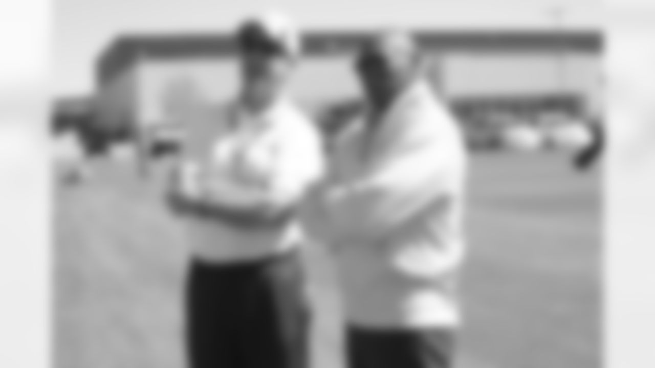 Fox talks with Hall-of-Famer Floyd Little during a training camp practice.