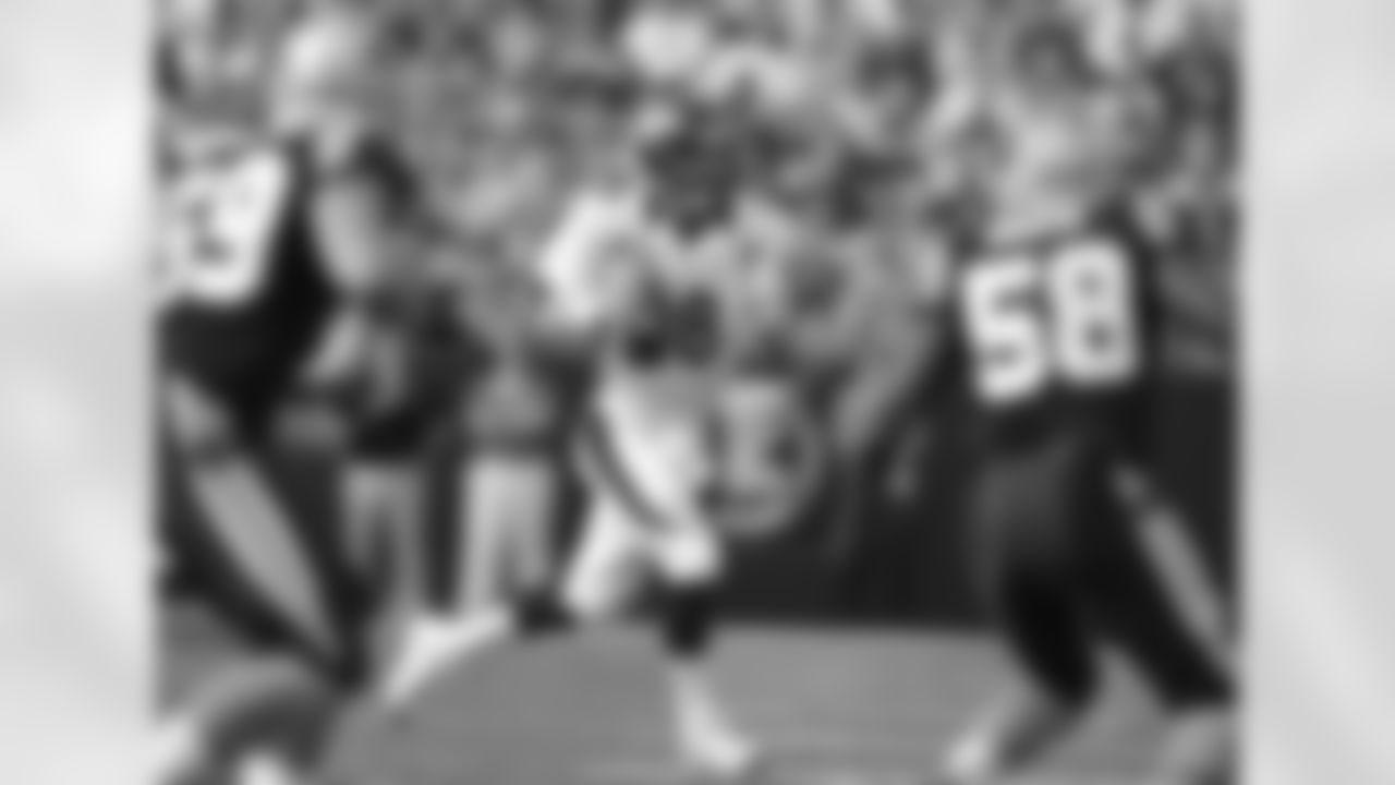 Manning rolls out to his left looking for a receiver.