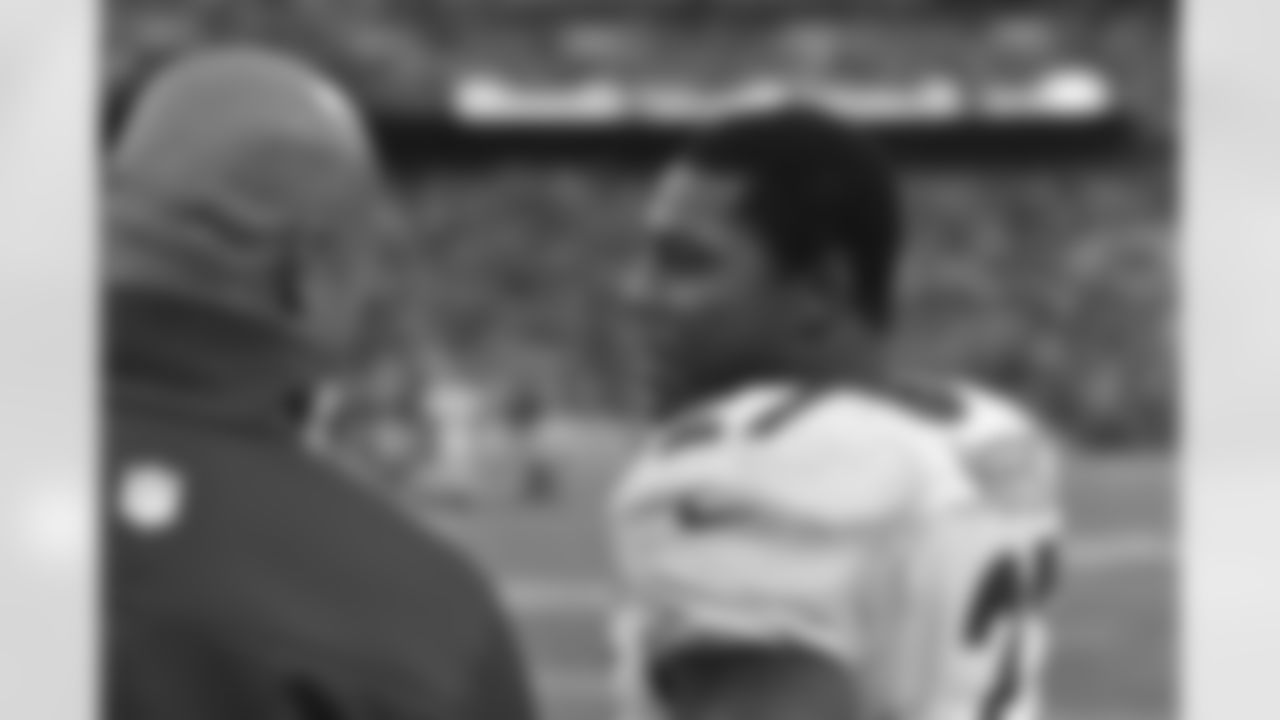 Moreno talks with Running Backs Coach Eric Studesville on the sideline.
