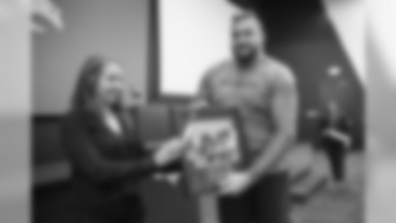 Dalton Risner receives the Community Rookie of the Year Award at a team meeting where the Denver Broncos Community Development department announced and recognized 2019 community champion award winners on December 12, 2019. (Photo by Ben Swanson)