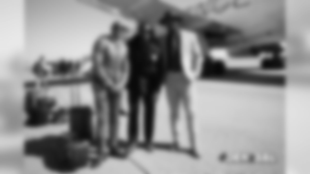 A group photo of Chris Harris Jr., Adam Jones and Von Miller as they walk to the plane on the tarmac at Denver International Airport during the team's travel for their Week 3 game against the Baltimore Ravens on September 22, 2018.