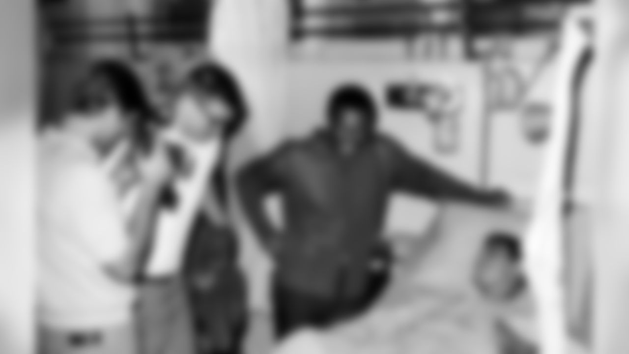 Los Angeles Rams running back Jack Snow (left) snaps a souvenir picture of the Denver Broncos running back Floyd Little and Spec. 4 Charles Perea (Salida, California) during a handshaking tour at a military hospital in Saigon on Jan. 28, 1970. Perea is in the hospital recovering from wounds from a booby trap explosion during an operation in the Mekong Delta. At center is St. Louis Cardinals defensive end, Charles Walker. (AP Photo/Dang Van Phuoc)
