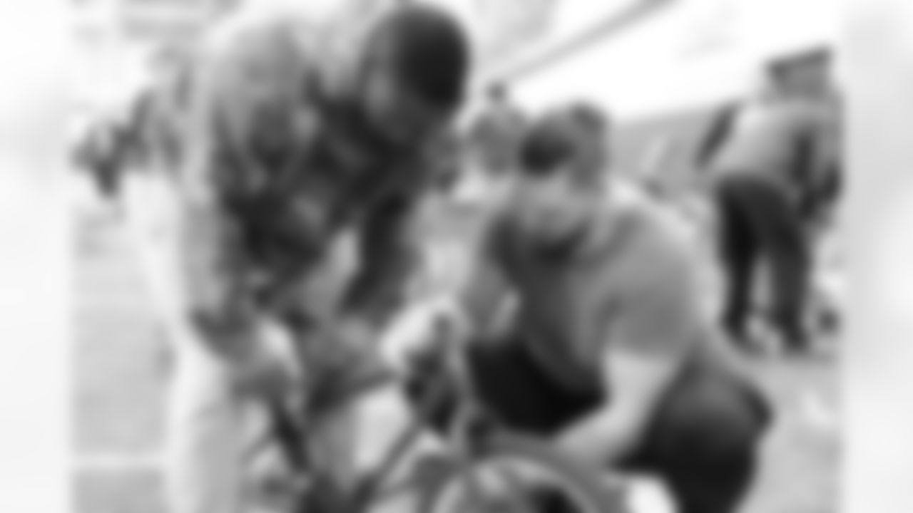 Will Parks and Derek Wolfe at a bike-building event for underprivileged kids led by the coaching staff on February 21, 2018.
