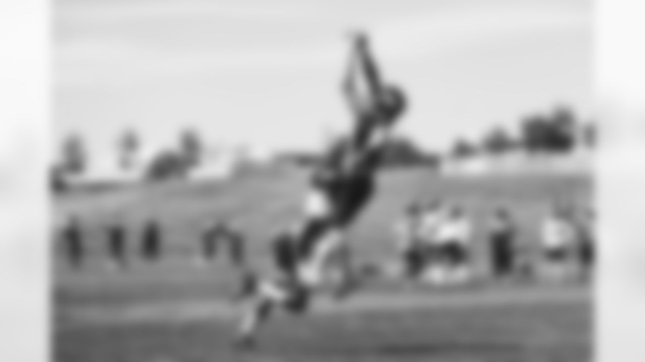 Shaun Beyer makes a leaping catch during the eighth day of OTA practices at UCHealth Training Center on June 8, 2021. (Photo by Ben Swanson)