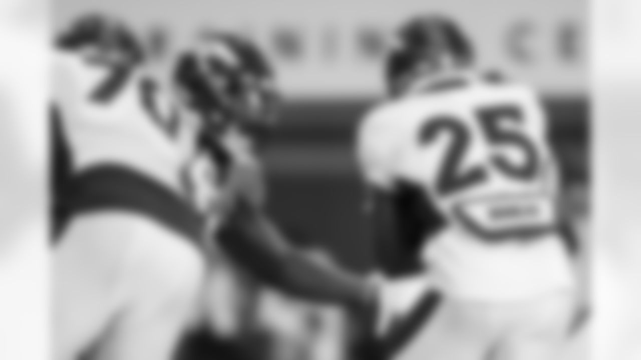 Dre'Mont Jones and Melvin Gordon III during practice on Day 10 of training camp at UCHealth Training Center on August 8, 2021. (Photo by Ben Swanson)