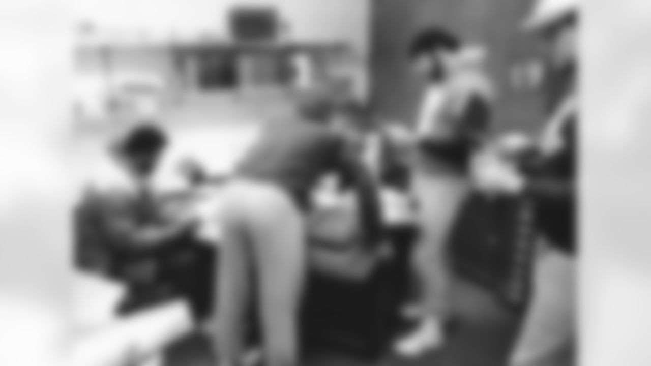 Lyle Alzado with teammates in an office in the 1970s.