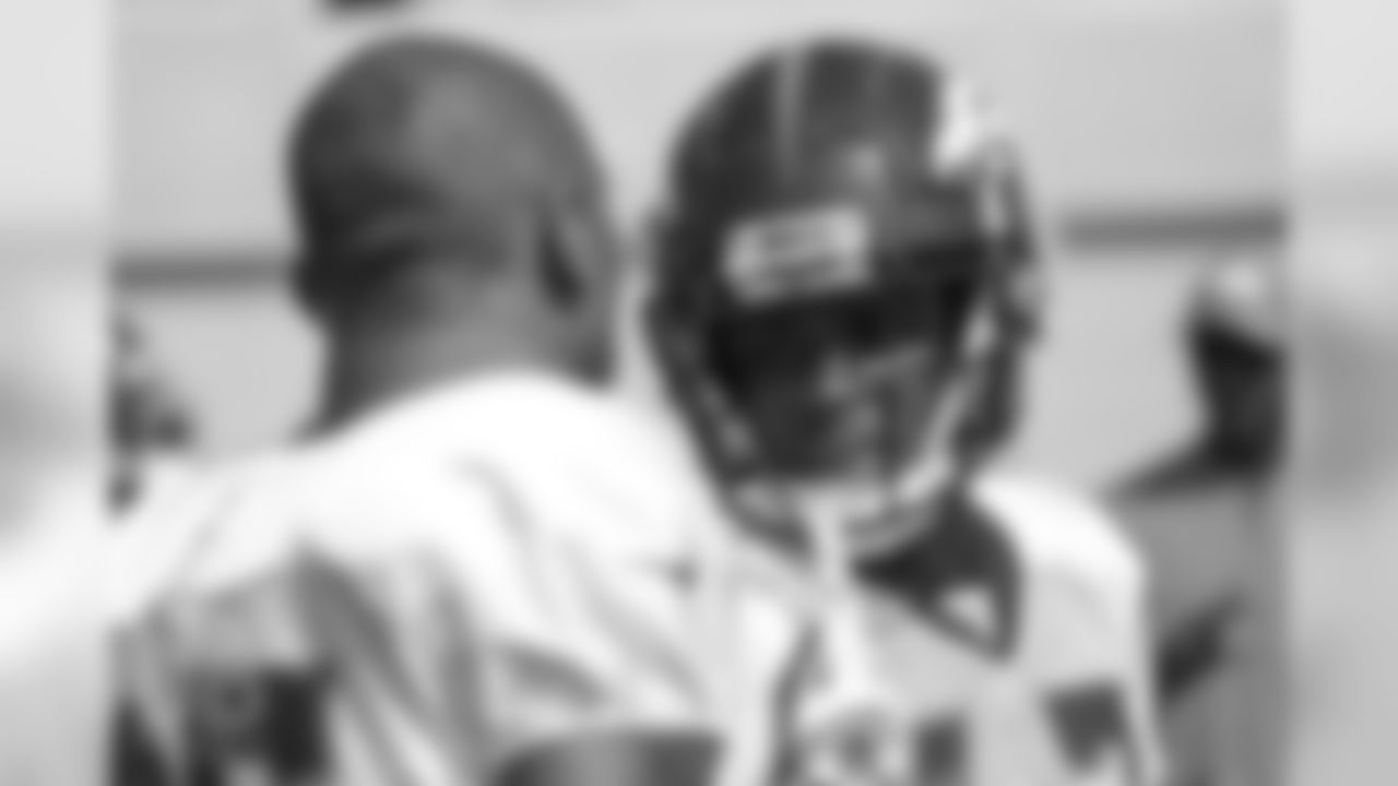 Cornerback C.J. Smith (28) talks with cornerback Chris Harris Jr. (25) during a practice at UCHealth Training Center on Aug. 13, 2018.