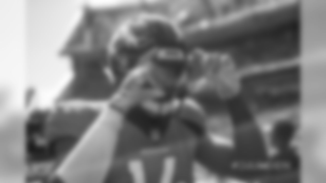 Courtland Sutton pretends to take a photo of Bradley Chubb during pregame warmups before the Broncos' game against the Oakland Raiders at Broncos Stadium at Mile High on September 16, 2018.