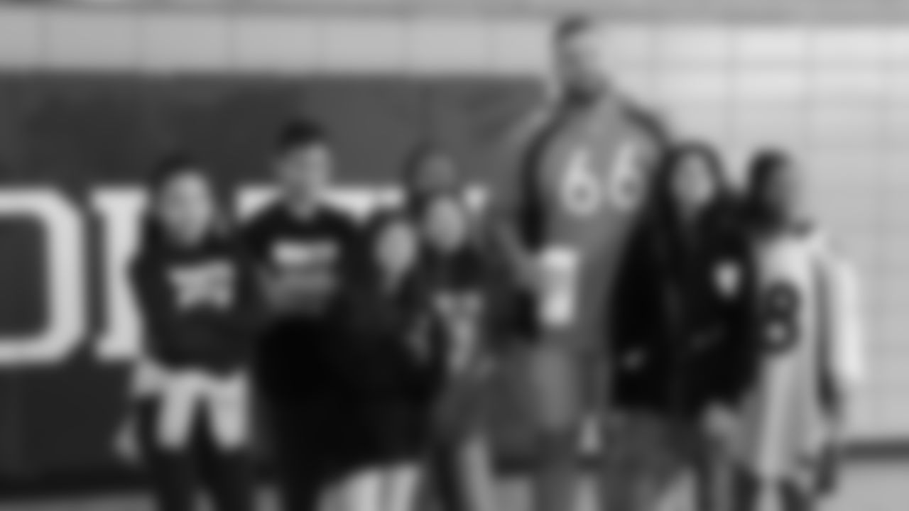 Dalton Risner poses with students after helping clean the gym at North Middle School in Aurora, Colorado for a Character Playbook School Service event on December 9, 2019. (Photo by Emily Simanskis)