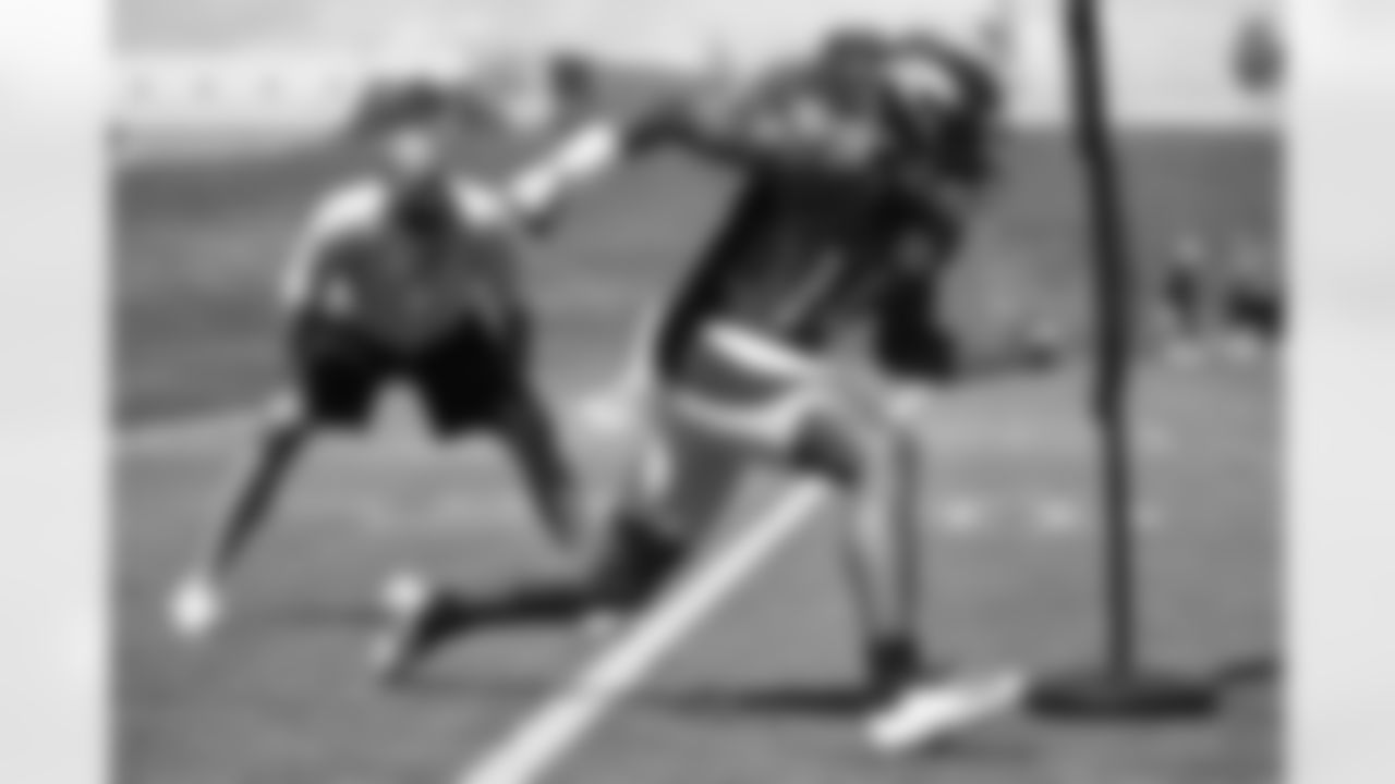 wide receiver Courtland Sutton (14) runs a drill in front of Wide Receivers Coach Zach Azzanni at the fourth day of OTAs on May 29, 2018 at UCHealth Training Center. (Ben Swanson)