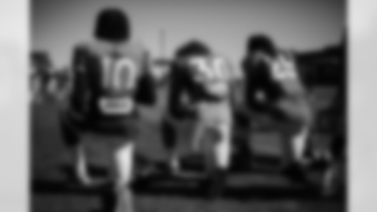 Jerry Jeudy, Phillip Lindsay and Melvin Gordon III kneel on the sideline during the 15th practice of training camp at UCHealth Training Center on September 2, 2020. (Photo by Ben Swanson)