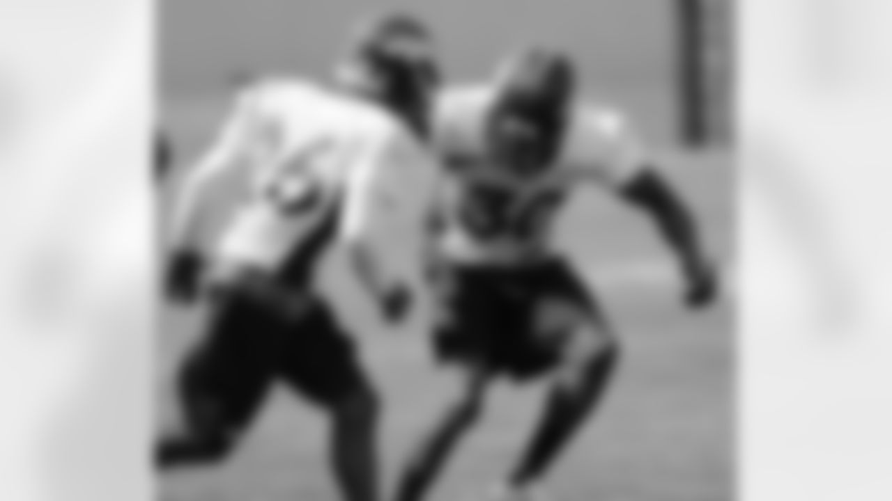 Safeties David Bruton and Rahim Moore work through a drill.