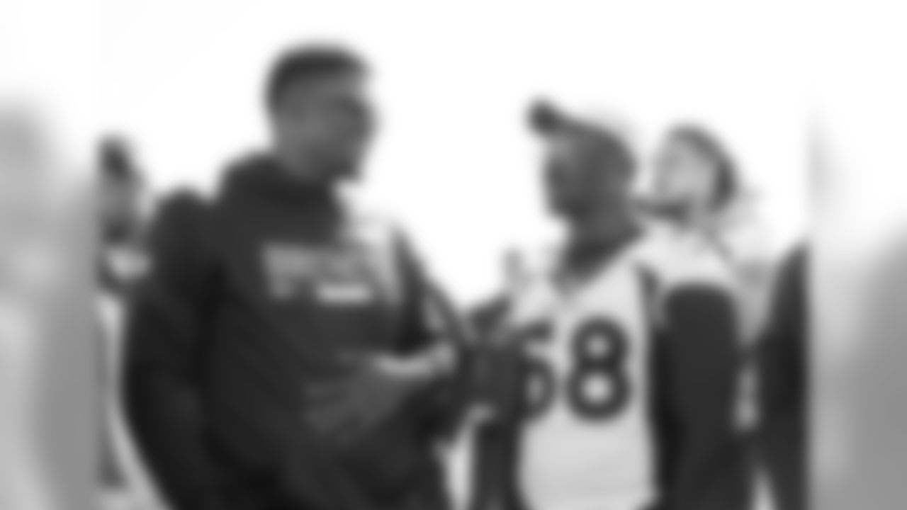 Ryan Clady talks with Von Miller as Broncos alumni watch the team's walkthrough and meet with current players and coaches afterward on October 12, 2019. (Photo by Jeremy Rincon)