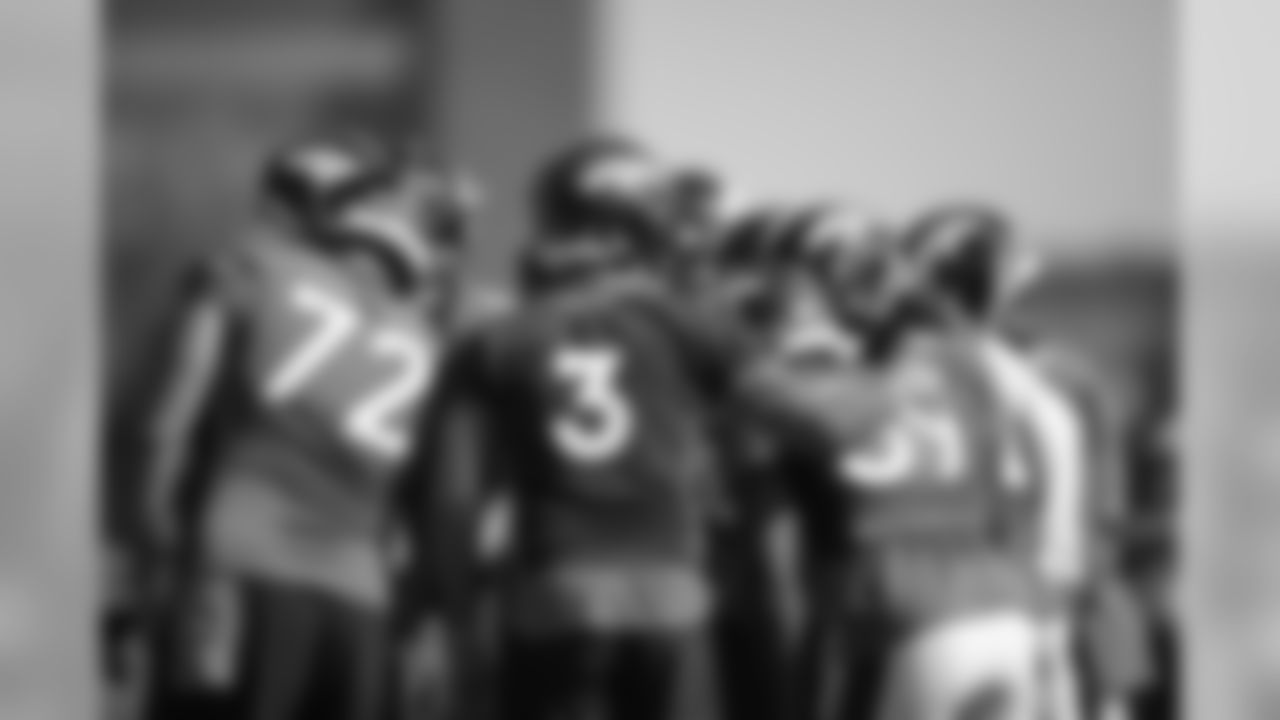 Drew Lock puts his arm on Jeremy Cox in the huddle with the offense during the first training camp practice at UCHealth Training Center on August 14, 2020. (Photo by Ben Swanson)