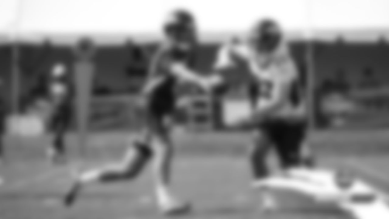 Joe Flacco hands the ball off to Devontae Booker during practice on Day 11 of training camp on July 30, 2019.