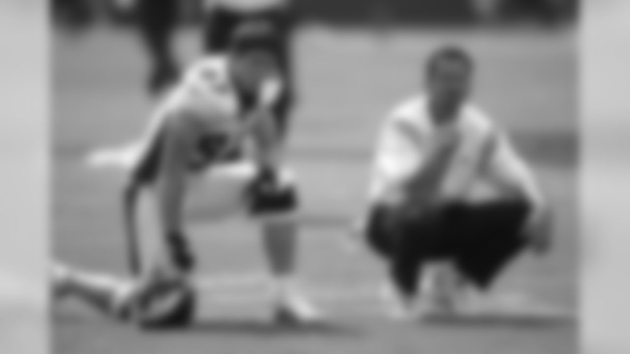 Ed McCaffrey and Steve Watson watch players during the pregame drills against the Cincinnati Bengals at Paul Brown Stadium in Cleveland, Ohio on September 7, 2003.