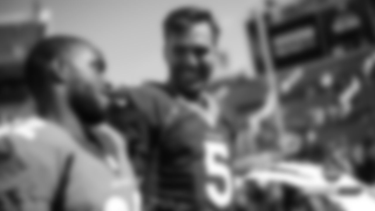 Joe Flacco talks with Kareem Jackson after practice on Day 9 of training camp at Broncos Stadium at Mile High on July 27, 2019.