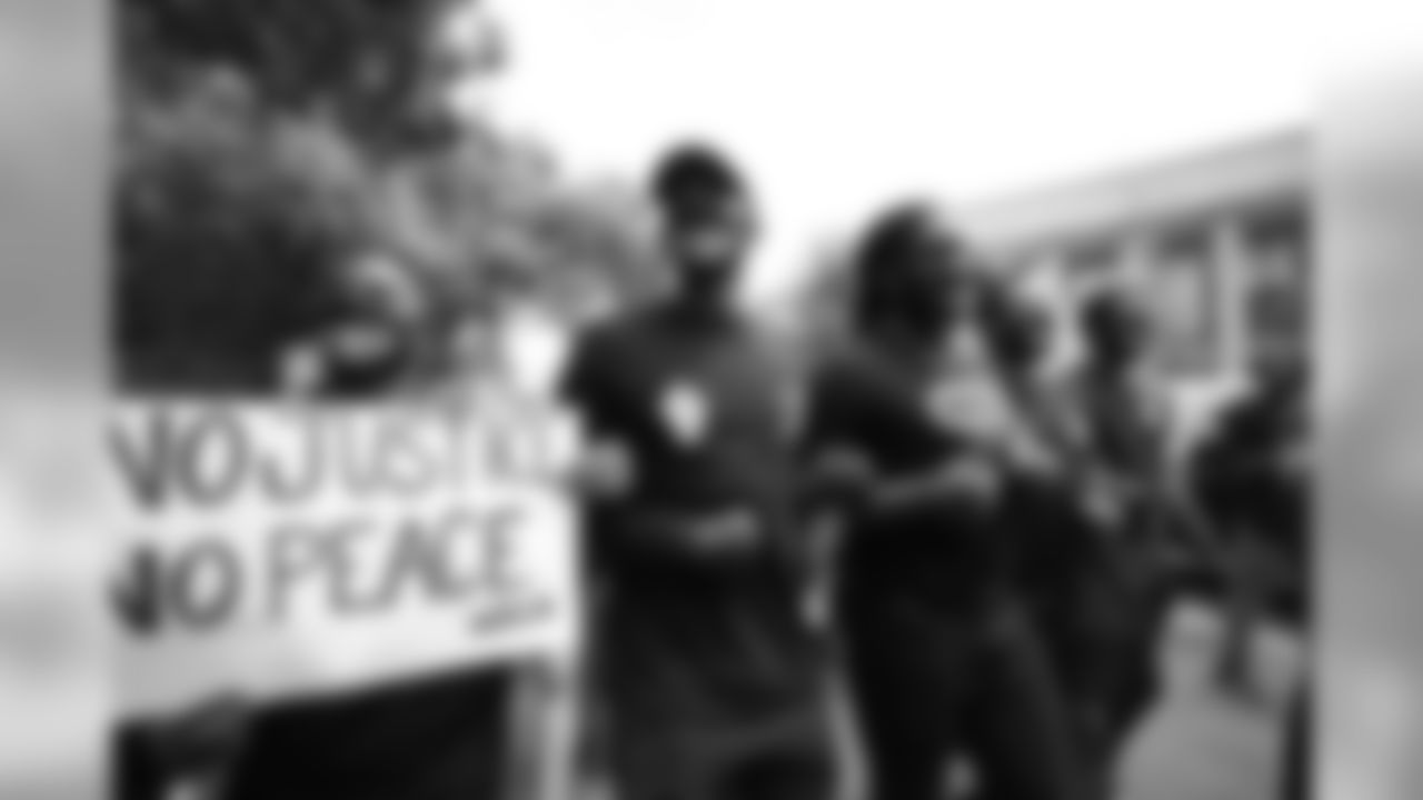 Courtland Sutton, Alexander Johnson lock arms with protesters during a protest for racial justice on June 6, 2020 on the streets of downtown Denver, Colorado. Denver Broncos coaches and players came out to give their support.
Photo by Gabriel Christus