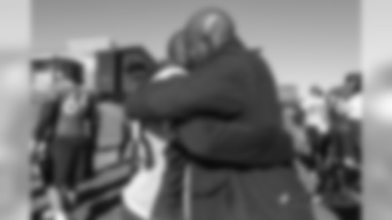 Former Broncos linebacker Al Wilson hugs Darian Stewart at practice on December 13, 2018 at UCHealth Training Center.