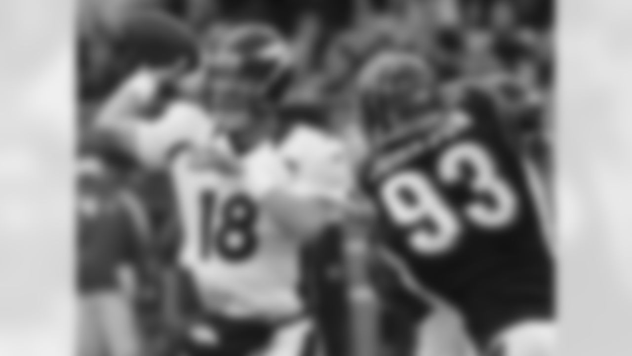 Manning gets rid of the ball in the face of pressure from defensive end Michael Johnson.