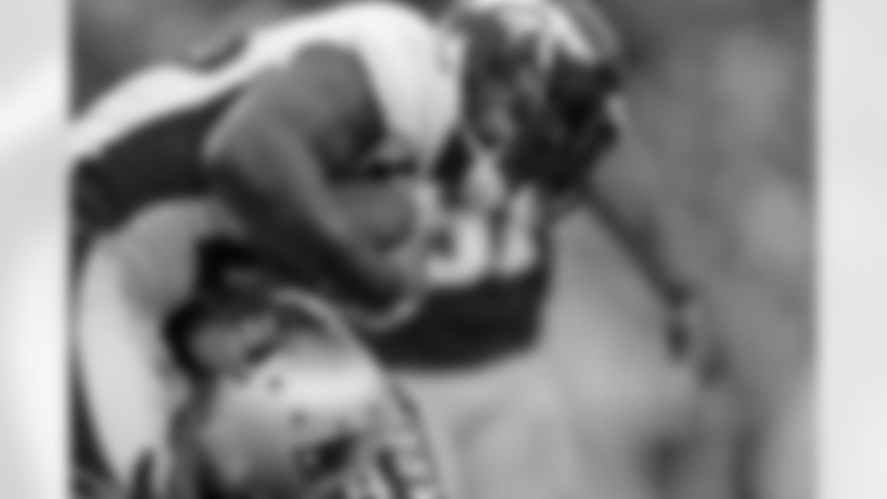 RB Willis McGahee fights through a Patriots tackler during the first half against the New England Patriots.