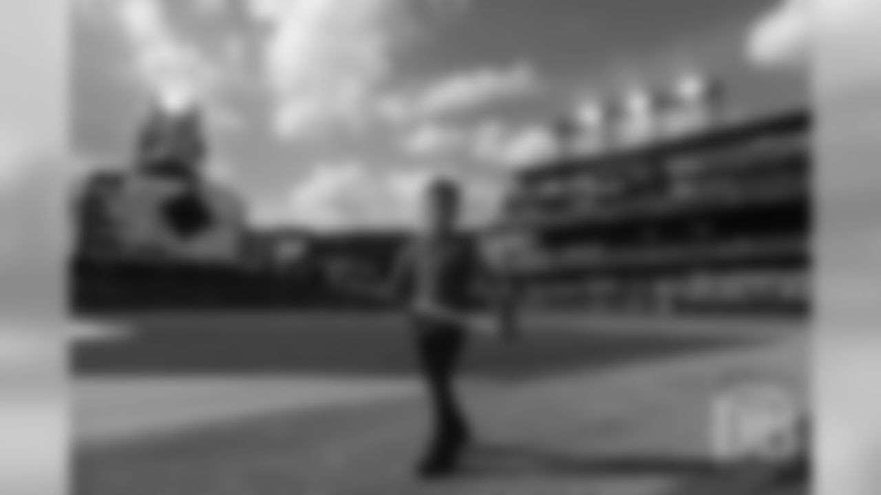 Emmanuel Sanders' son Princeton holds a bat as he walks the bases during a visit to the Colorado Rockies' clubhouse at Coors Field on May 29, 2019.