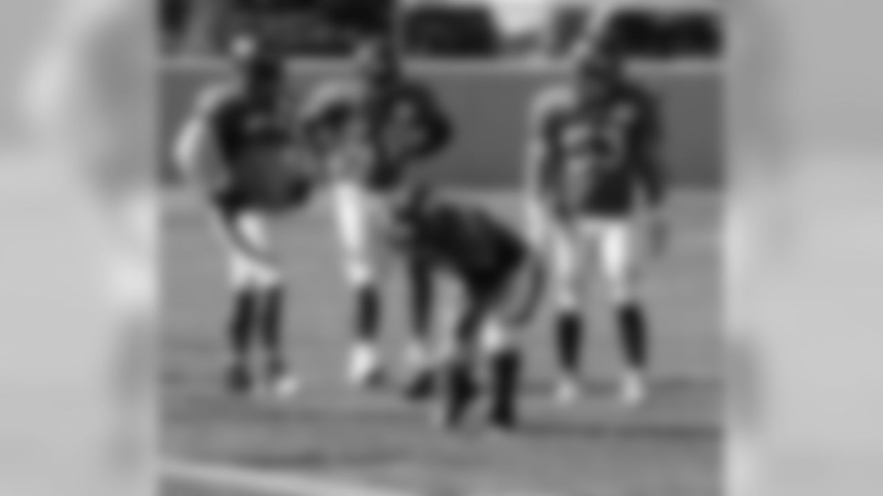 Linebackers work through a fumble recovery drill.