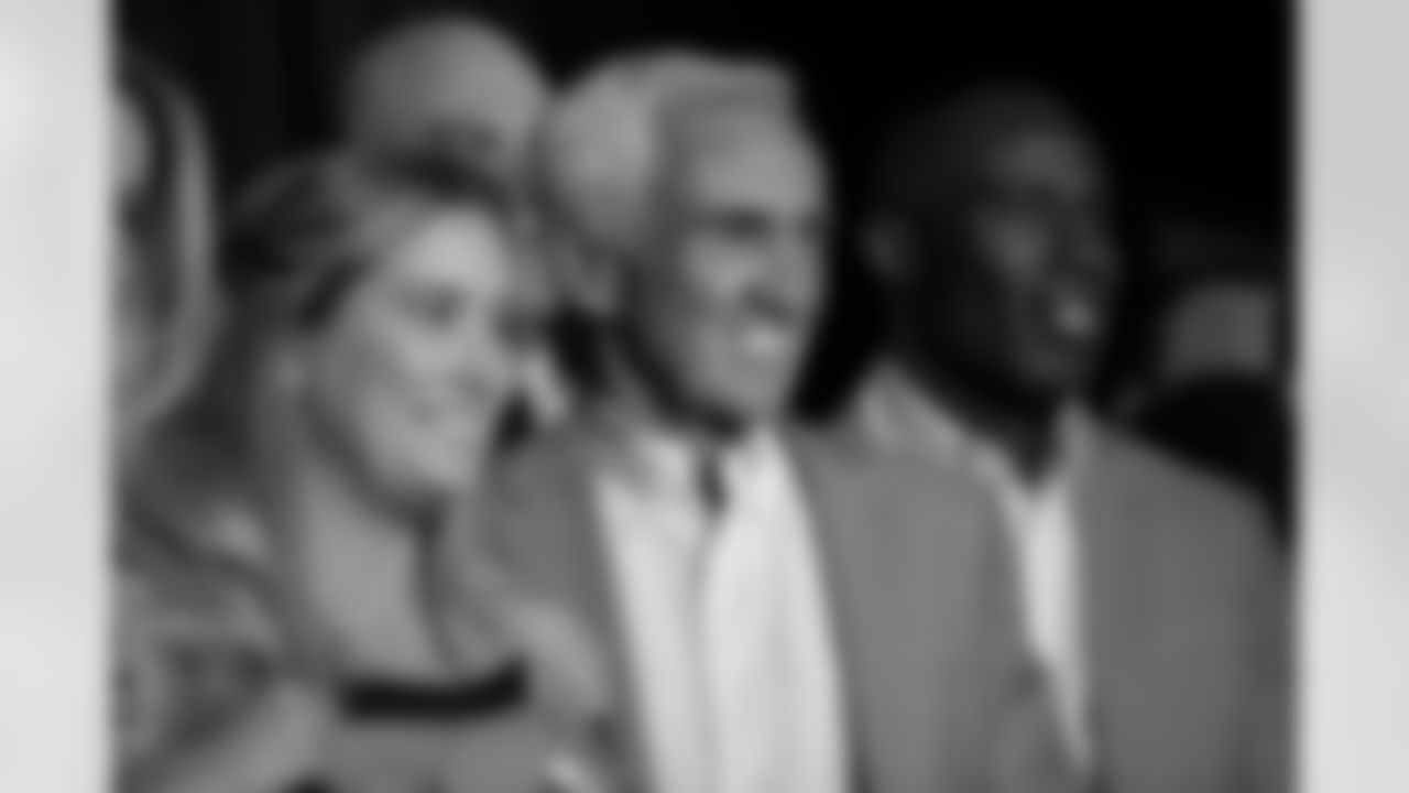 Mike Shanahan, next to Brittany Bowlen and Terrell Davis, during the Alumni Weekend orange jacket presentation and Mike Shanahan's induction speech at Empower Field at Mile High in Denver, Colorado on October 15, 2021. (Photo by Ben Swanson)