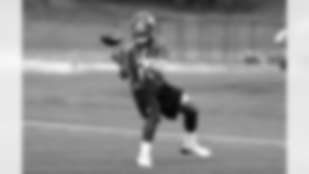WR Gerell Robinson looks the ball into his hands.