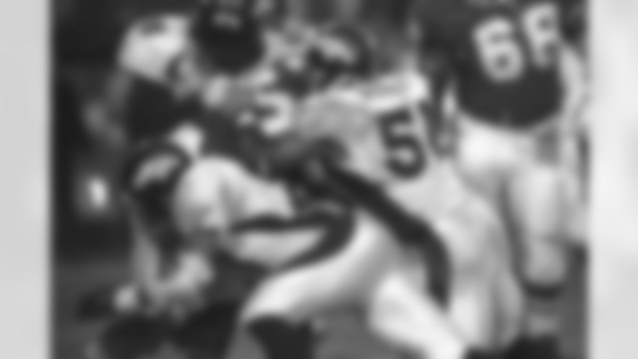 Kansas City: John Mobley and his defensive teammates make a tackle during a second round playoff game against the Chiefs against the Kansas City Chiefs at Arrowhead Stadium in Kansas City, MO on January 4, 1998.