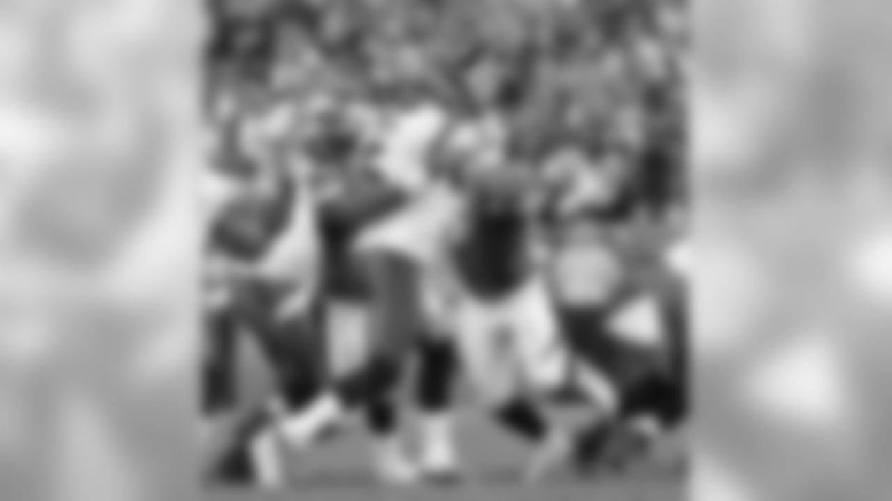 DEs Derek Wolfe and Malik Jackson pressure Freeman.