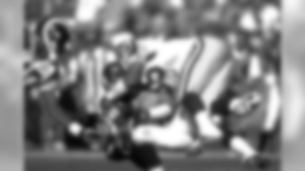 Ed McCaffrey gets tackled after making a touchdown catch against the St. Louis Rams at Mile High Stadium in Denver, CO on September 14, 1997.