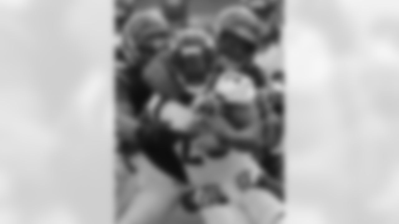 The running back fights for yardage.