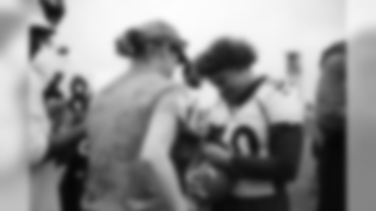 Phillip Lindsay signs autographs for military members from the USAA Salute to Service NFL Boot Camp after practice on August 21, 2019 at UCHealth Training Center.