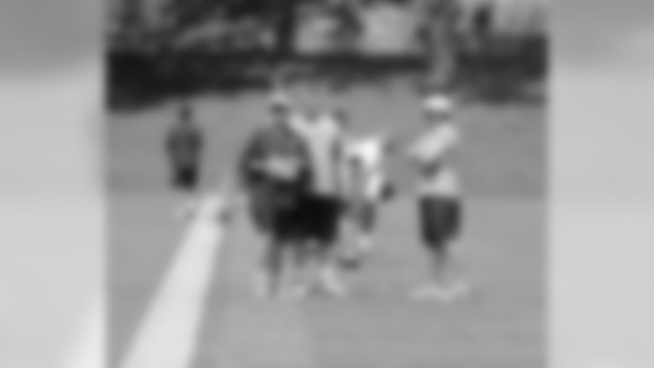 Head Coach John Fox, Tight Ends Coach Clancy Barone and G Chris Kuper talk before practice.