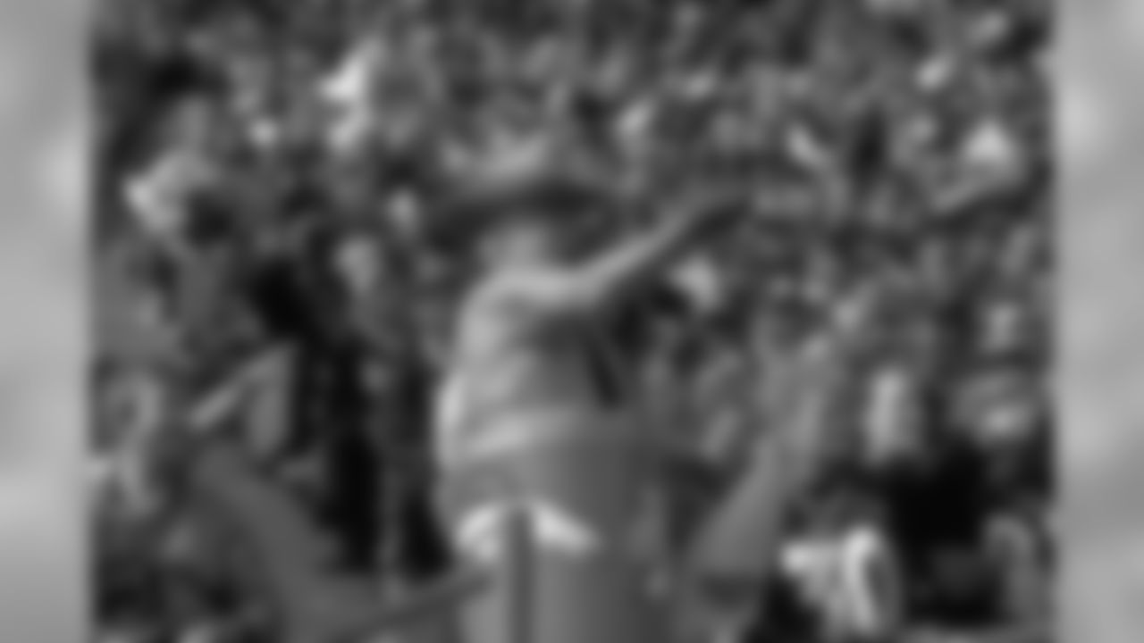 Barrel Man tries to the get the fans pumped up against the New York Jets at Mile High Stadium in Denver, CO on October 3, 1999.